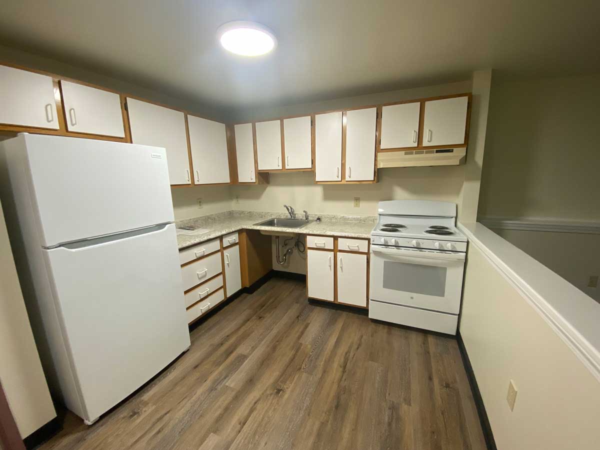 View of the refrigerator and stove in the kitchen