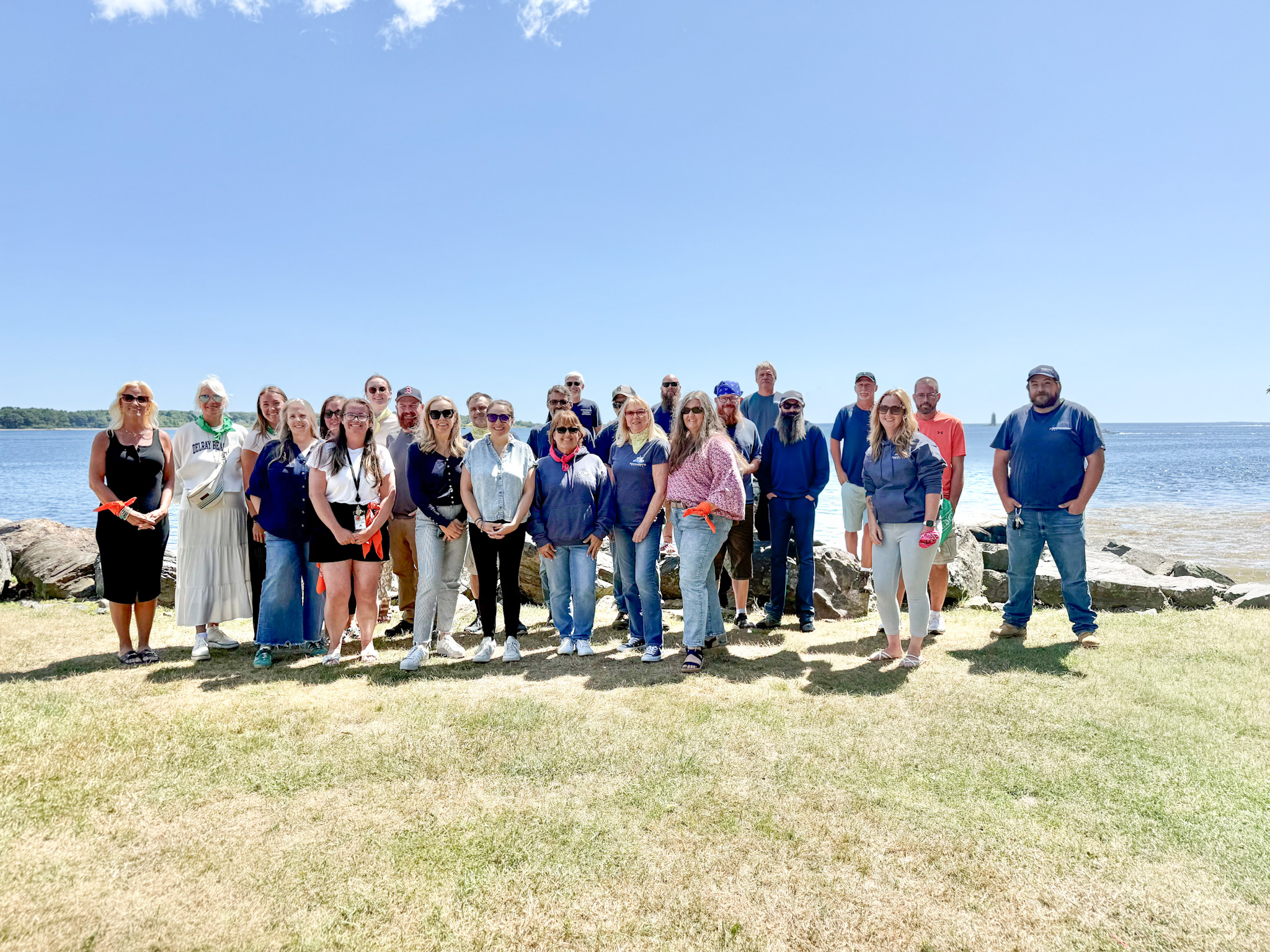 Group picture of the staff in front of the water
