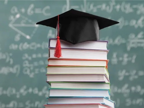 Graduation cap on top of a stack of books