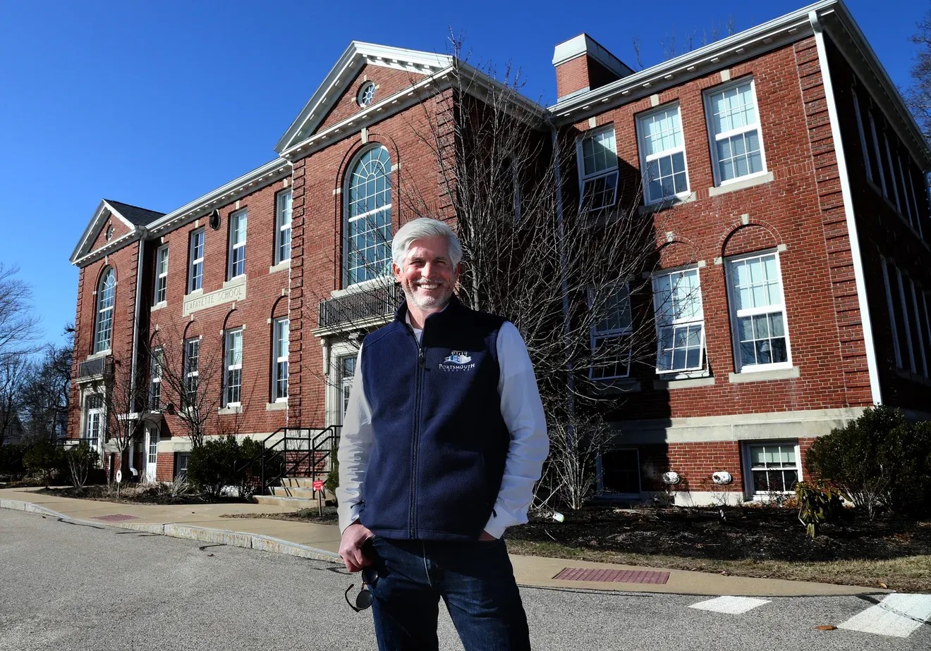 Craig Welch standing in front of apartments