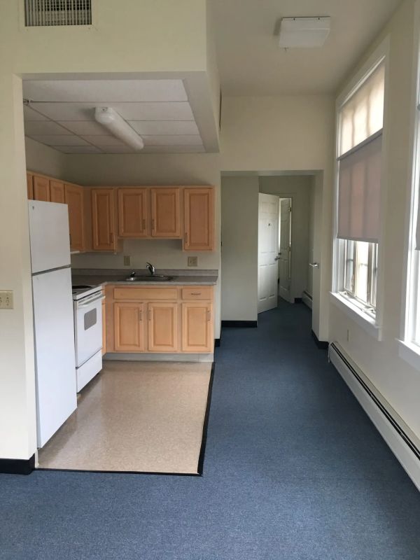 Kitchen on the left leading to the bedroom