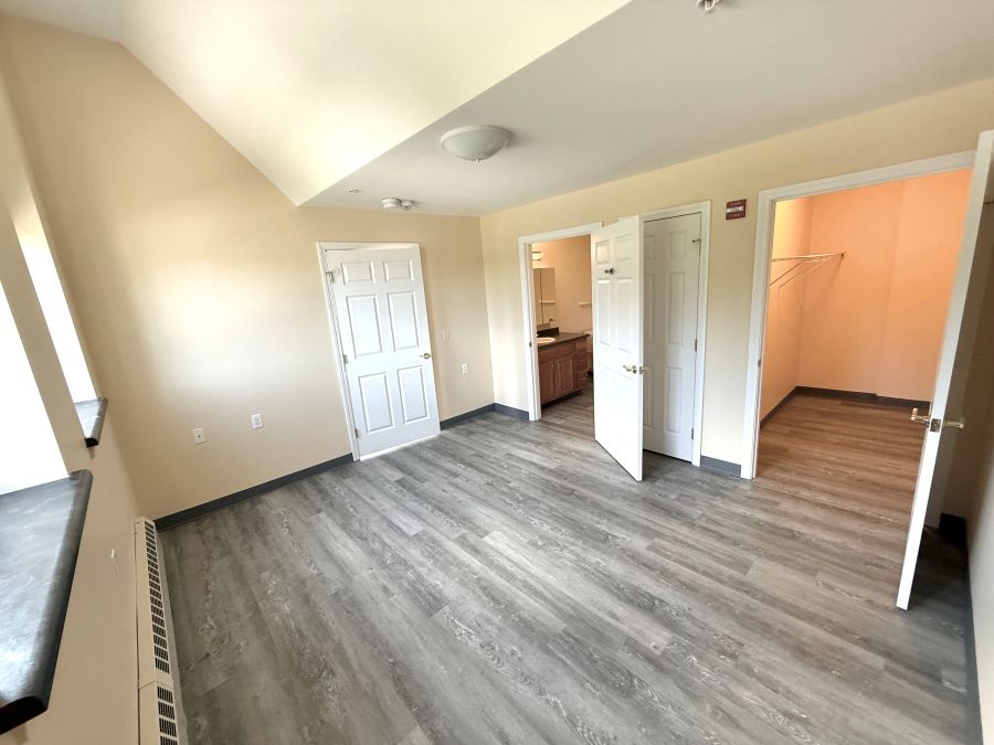 View of the bedroom closet and bathroom doorways