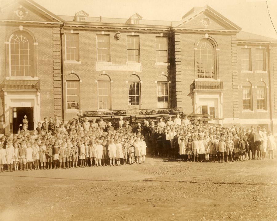 Historic picture of the building with children standing in front